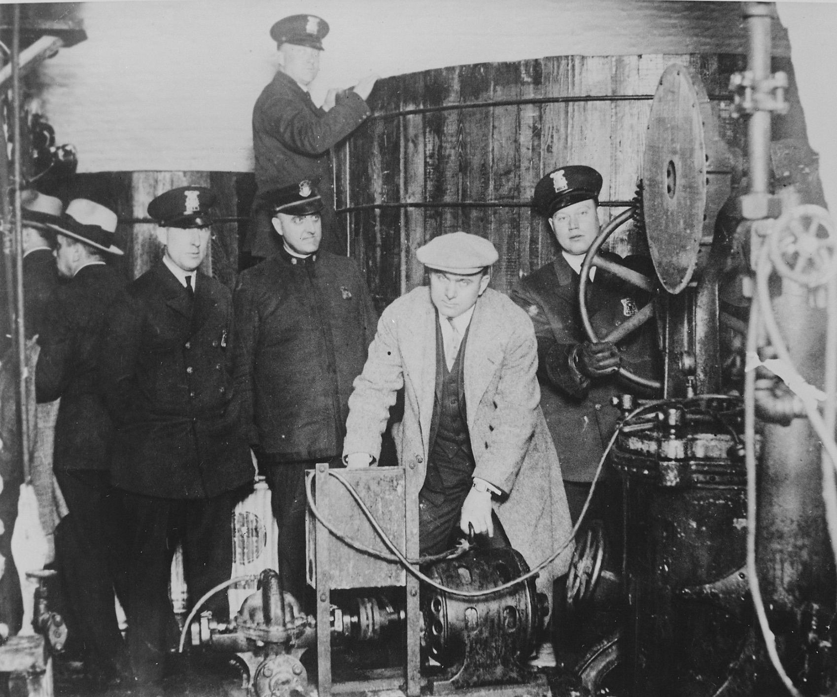 Michigan and Detroit policemen inspect the equipment used in a clandestine brewery in a bust
